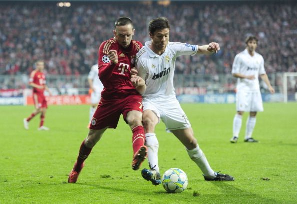 Bayern's Franck Ribery battles with Madrids Xabi Alonso.