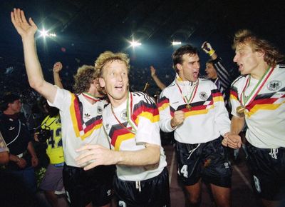 Andreas Brehme leads the German celebrations in 1990.